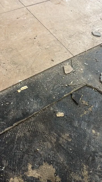 Black bitumen mastic floor removal in a W12 flat